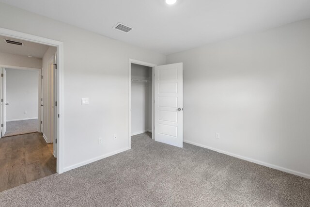 unfurnished bedroom with carpet and a closet