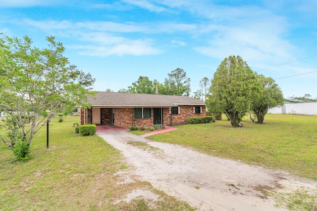 105 Goff St, Perry, FL 32347 - ranch-style home featuring driveway, a front yard, brick siding, and a carport