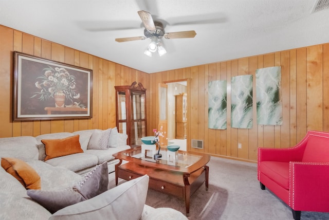 105 Goff St, Perry, FL 32347 - living area with wood walls, carpet flooring, ceiling fan, and baseboards