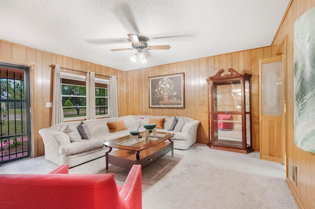105 Goff St, Perry, FL 32347 - living room with carpet, a ceiling fan, a textured ceiling, and wooden walls