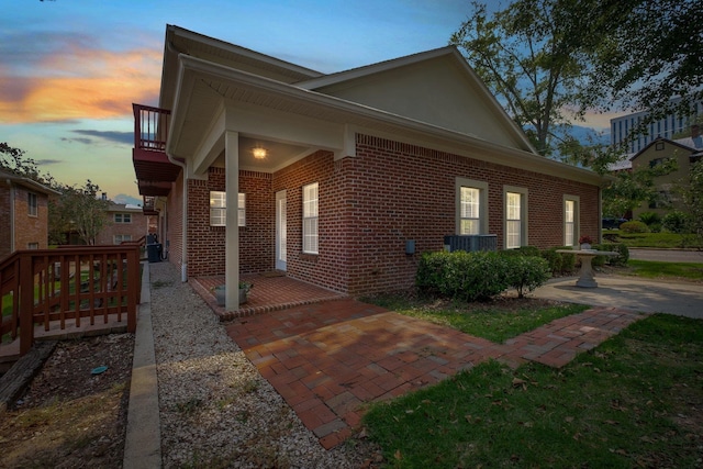 property exterior at dusk with a balcony