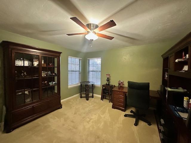 office space with light carpet and ceiling fan