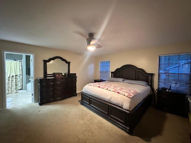 bedroom with light colored carpet and ceiling fan