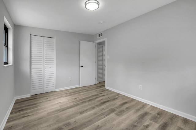2309 Oxford Rd, Tallahassee, FL 32304 - unfurnished bedroom with wood finished floors, baseboards, and a closet
