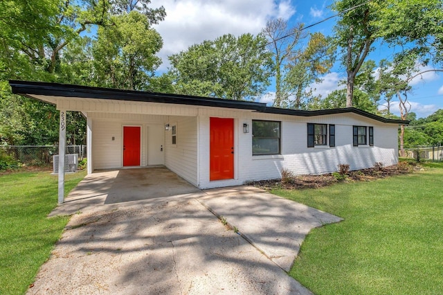 2309 Oxford Rd, Tallahassee, FL 32304 - view of front of house with concrete driveway, an attached carport, and central AC unit