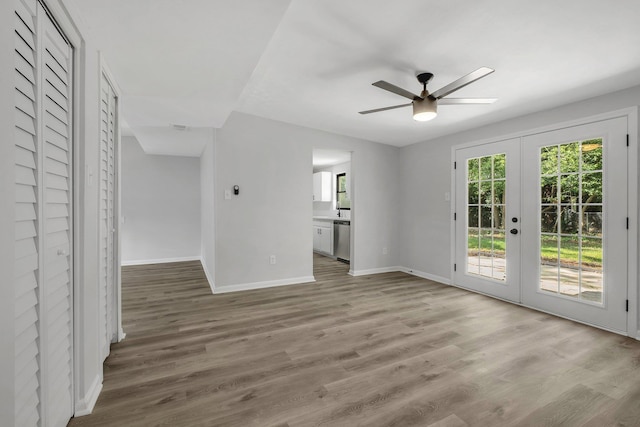 2309 Oxford Rd, Tallahassee, FL 32304 - unfurnished living room with baseboards, ceiling fan, french doors, and wood finished floors