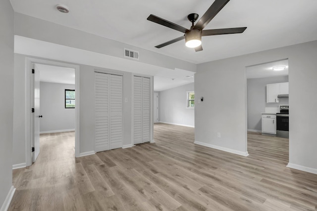 2309 Oxford Rd, Tallahassee, FL 32304 - unfurnished living room featuring a ceiling fan, light wood-style floors, and baseboards