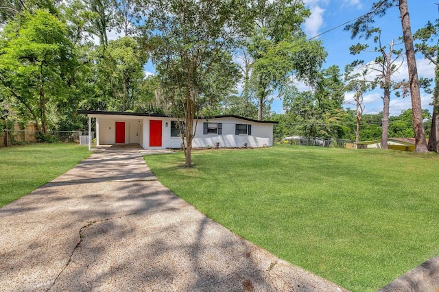 2309 Oxford Rd, Tallahassee, FL 32304 - view of front facade featuring asphalt driveway, a carport, and view of scattered trees