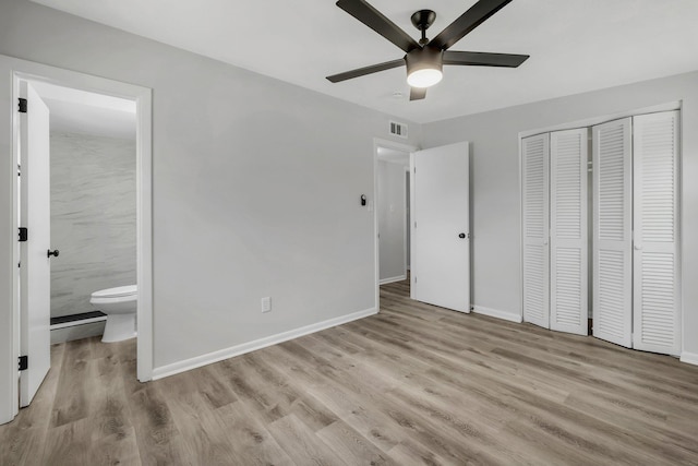 2309 Oxford Rd, Tallahassee, FL 32304 - unfurnished bedroom featuring wood finished floors, a closet, baseboards, and ensuite bathroom