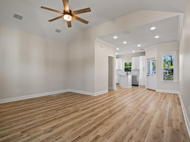 unfurnished living room featuring lofted ceiling, light wood-type flooring, and crown molding