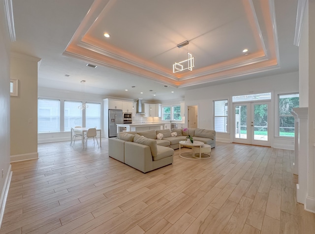 3353 Jasmine Hill Rd, Tallahassee, FL 32311 - living area with a tray ceiling, crown molding, french doors, healthy amount of natural light, and light wood-style flooring