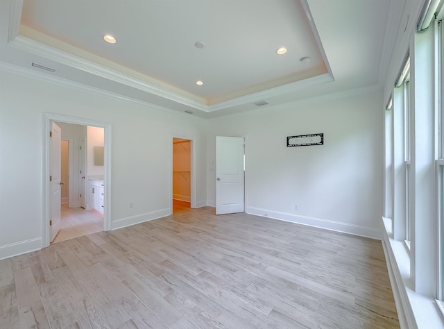 3353 Jasmine Hill Rd, Tallahassee, FL 32311 - unfurnished bedroom with a raised ceiling, crown molding, a spacious closet, light wood finished floors, and recessed lighting