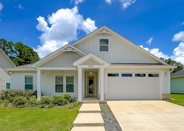 3353 Jasmine Hill Rd, Tallahassee, FL 32311 - view of front of home with concrete driveway, board and batten siding, a front lawn, and a porch
