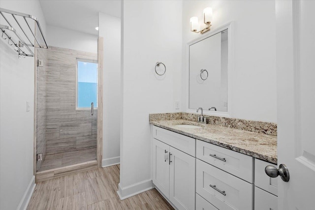 bathroom with vanity and a shower with shower door