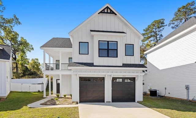 modern inspired farmhouse featuring cooling unit, a garage, a front lawn, and a balcony