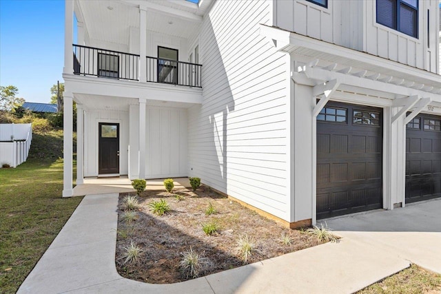 doorway to property with a garage and a balcony