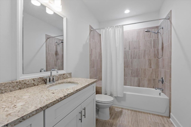 full bathroom with shower / tub combo, vanity, and toilet