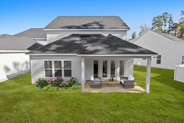 back of house with a patio, a lawn, and french doors