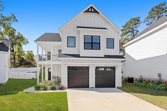 modern farmhouse with cooling unit, a balcony, a garage, and a front lawn