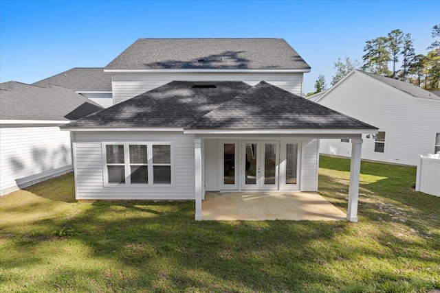 back of property featuring french doors, a yard, and a patio area