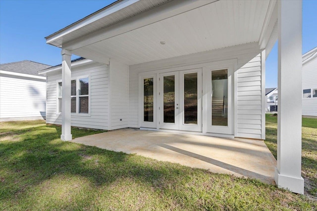 rear view of house with a patio, a yard, and french doors