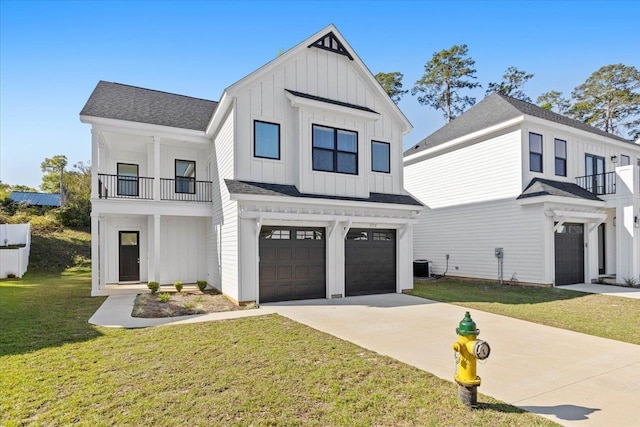 modern inspired farmhouse featuring a garage, a front yard, a balcony, and central air condition unit