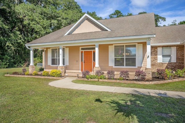 view of front of property featuring a front yard and covered porch