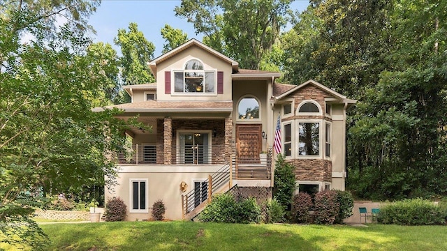 3508 Trillium Ct, Tallahassee, FL 32312 - view of front of house with stucco siding, stone siding, a front yard, and stairway