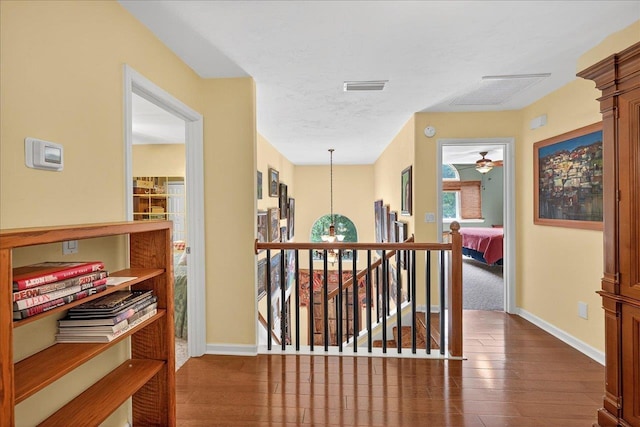 3508 Trillium Ct, Tallahassee, FL 32312 - corridor with dark wood-style floors and an upstairs landing