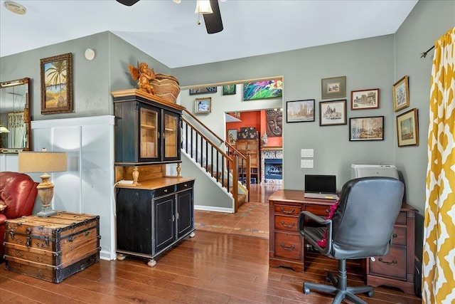 3508 Trillium Ct, Tallahassee, FL 32312 - home office with ceiling fan, dark wood finished floors, and a fireplace