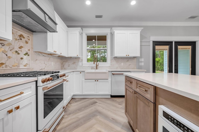 205 Fairway Dr, Havana, FL 32333 - kitchen featuring white appliances, a sink, wall chimney range hood, ornamental molding, and plenty of natural light