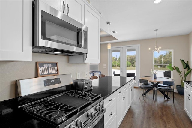 5735 Pinebarren Rd, Tallahassee, FL 32303 - kitchen with white cabinets, stainless steel appliances, french doors, and an inviting chandelier