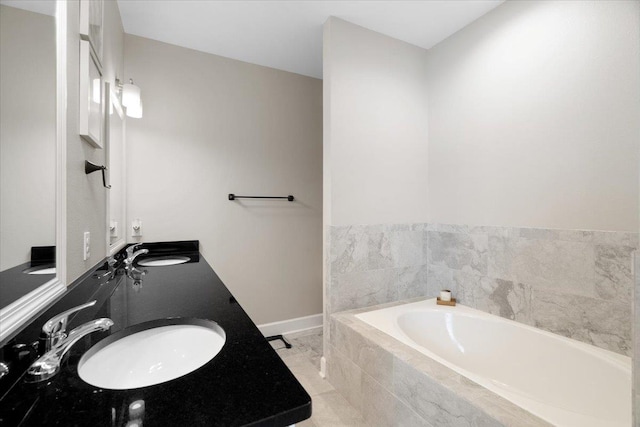 5735 Pinebarren Rd, Tallahassee, FL 32303 - bathroom with a bath, baseboards, a sink, and double vanity