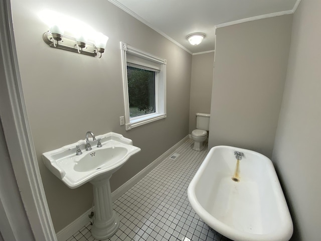 bathroom with tile patterned flooring, ornamental molding, a bath, and toilet