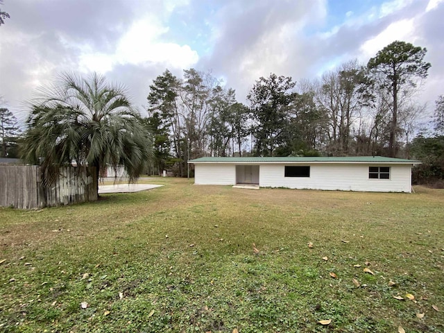 back of house with a lawn