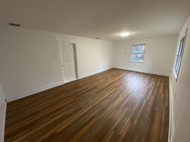 spare room with dark hardwood / wood-style flooring