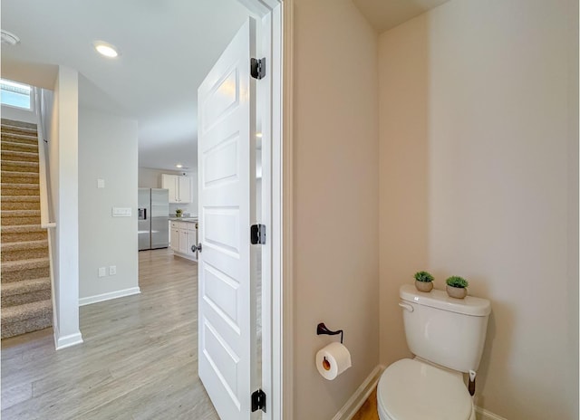 bathroom featuring hardwood / wood-style flooring, vanity, and toilet