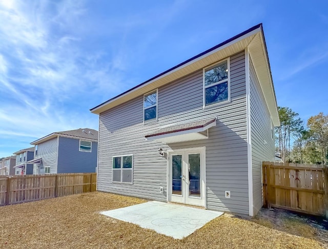 rear view of house with a patio area and french doors