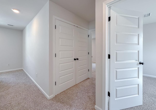 hallway with light colored carpet