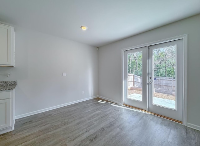 interior space with french doors and light wood-type flooring