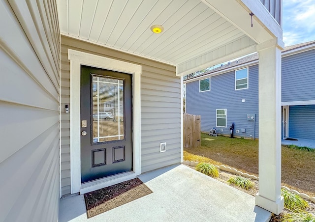 view of exterior entry featuring a porch