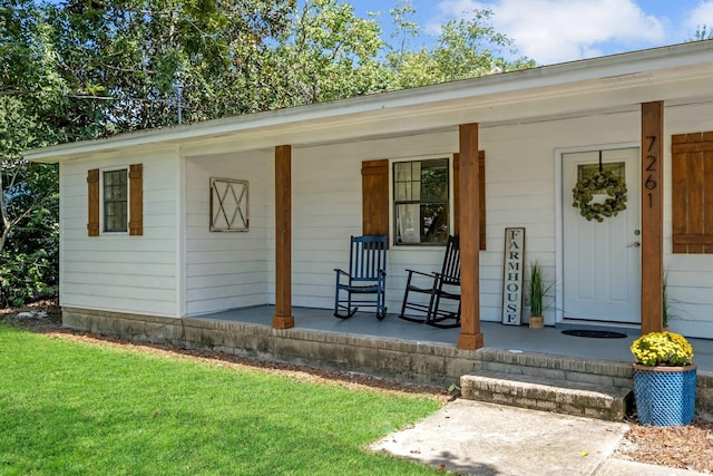 view of exterior entry with a porch