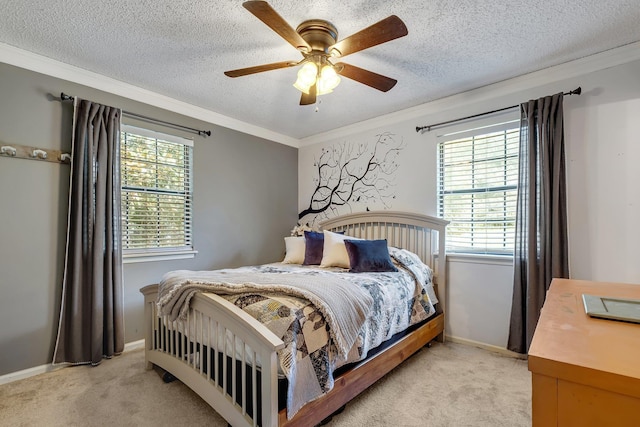 carpeted bedroom with ceiling fan, a textured ceiling, and ornamental molding