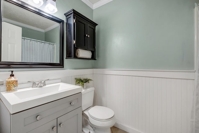 bathroom featuring vanity, toilet, and ornamental molding