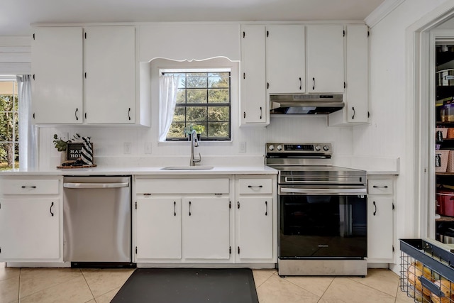 kitchen with white cabinets, light tile patterned floors, stainless steel appliances, and sink