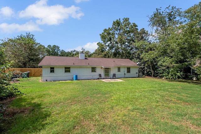 rear view of house with a patio area and a yard