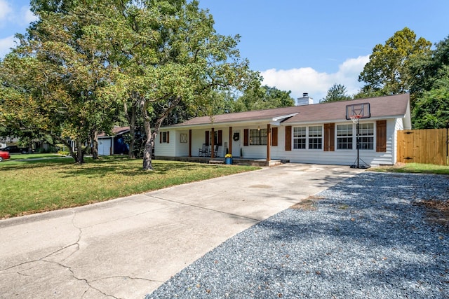 ranch-style home with a front yard and a porch