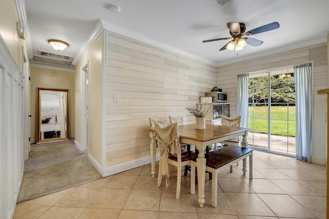 dining space featuring ceiling fan, crown molding, and light tile patterned flooring