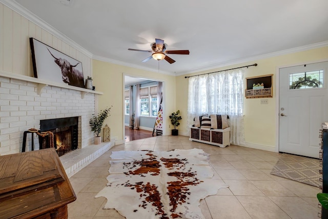 interior space with a fireplace, a healthy amount of sunlight, ceiling fan, and crown molding