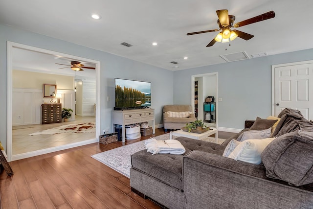 living room featuring ceiling fan and hardwood / wood-style flooring